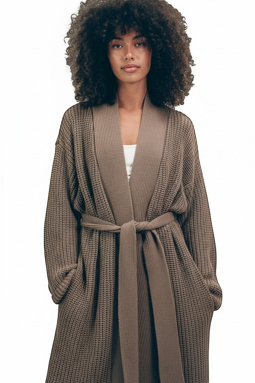 AMI CHÉRIE DESIGN STUDIO longline brown knit robe with belt and pockets, featuring a deep V-neck and relaxed fit.